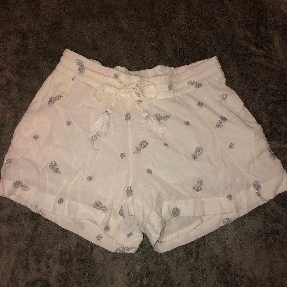 white shorts with silver pineapples on them